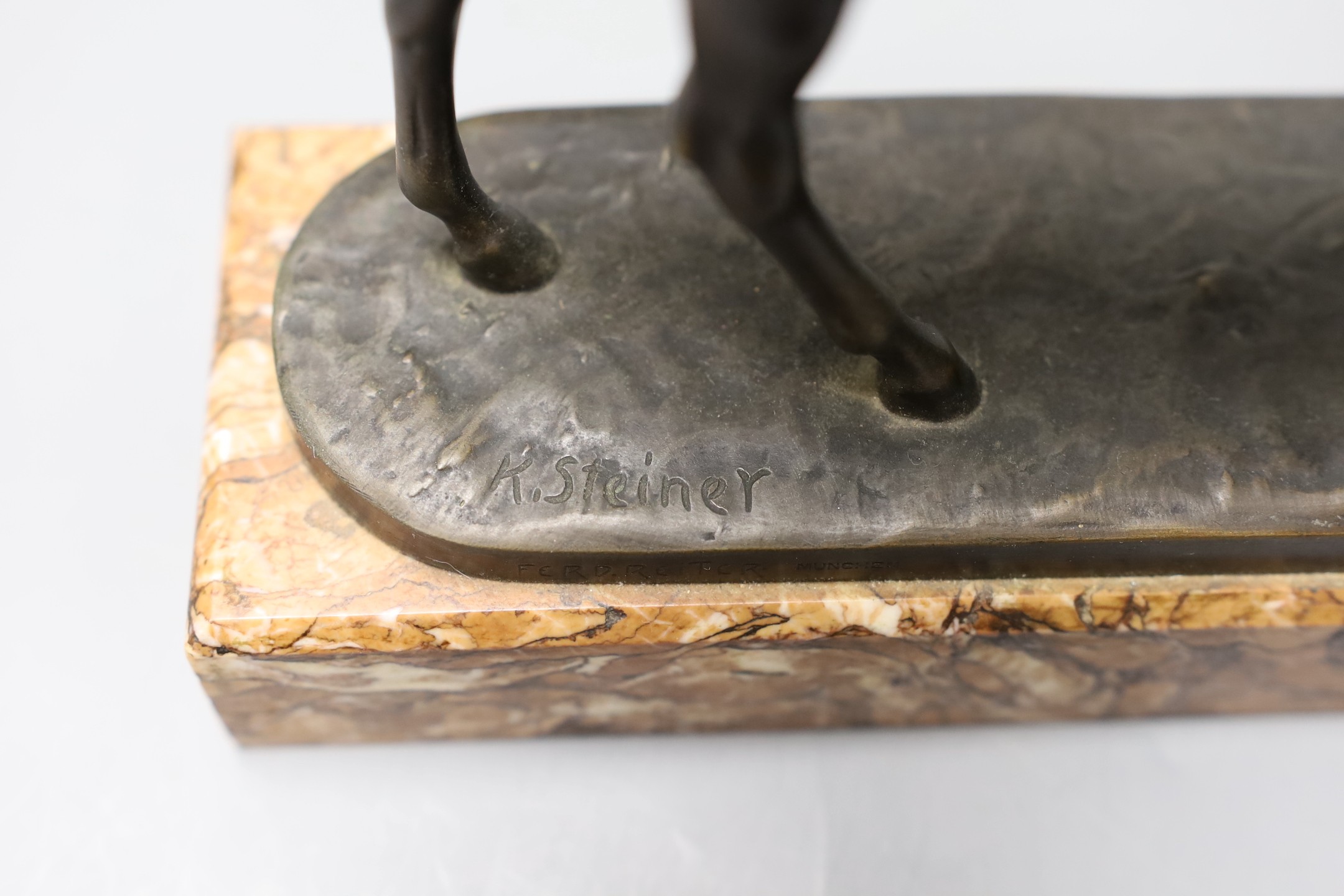 A 20th century bronze model of a horse, signed ‘K.Steiner’ the edge of the base incised ‘Ferd.Reiter Munchen’, on marble base, 22cm